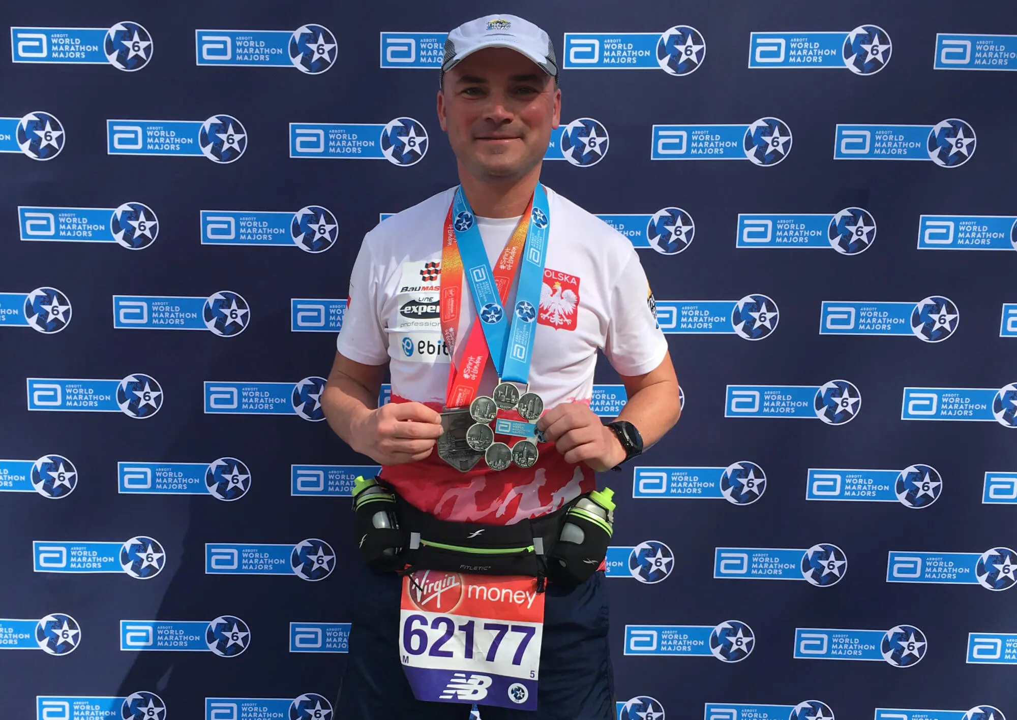 Runner holding Six Star Medal after completing the London Marathon